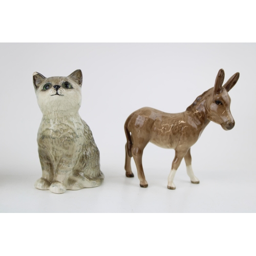 165 - Beswick to include an Ayrshire bull (horn af), a donkey, a grey kitten (damaged ear) and Royal Doult... 