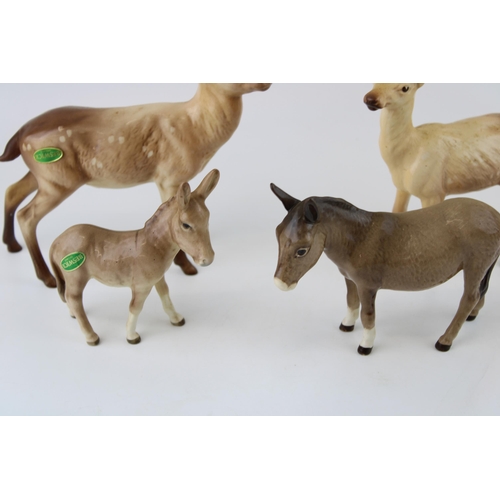 176 - Beswick animals to include a doe, a stag, a large donkey and a smaller donkey (4).