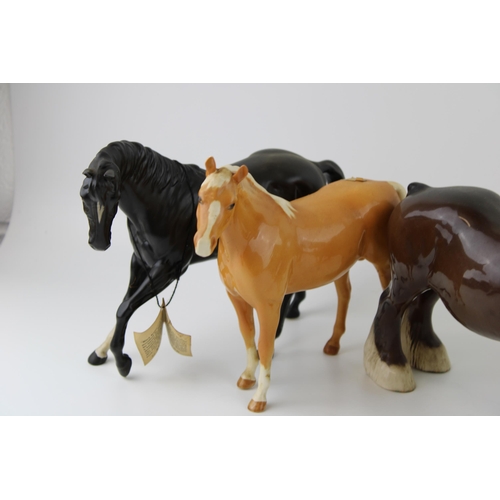 179 - Beswick to include a Black Beauty, a palomino horse, a brown 818 shire and 1 other (4).