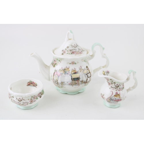 210 - Royal Doulton Brambly Hedge miniature tea service to include a teapot, a milk jug and sugar bowl (3)... 