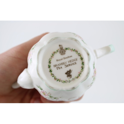 210 - Royal Doulton Brambly Hedge miniature tea service to include a teapot, a milk jug and sugar bowl (3)... 