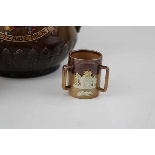 223 - Royal Doulton to include two miniature stoneware items such as a tyg and a jug, with an Elizabeth II... 