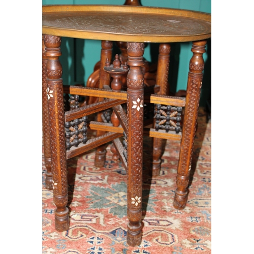 184 - A vintage middle eastern hand carved occasional table with mother of pearl inlay and heavy copper to... 