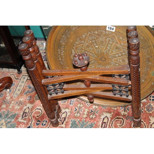 184 - A vintage middle eastern hand carved occasional table with mother of pearl inlay and heavy copper to... 