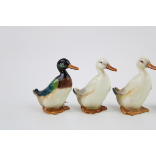 253 - A collection of Royal Doulton small ducks, painted in naturalistic colours, 6cm tall, to include thr... 