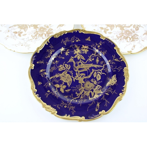 266 - A trio of Coalport plates with heavy gilded decoration of birds and foliage, two with white ground a... 