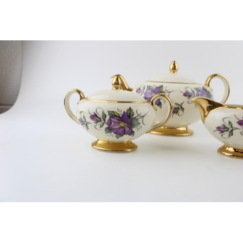 296 - Sadler purple flower tea set to include a teapot, lidded sugar and milk jug (3).