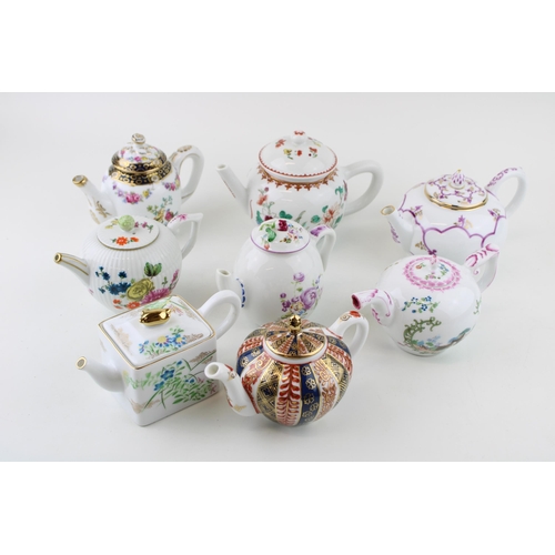 299 - A collection of Franklin Mint Victoria & Albert small teapots to include Meissen, Mennecy, Furstenbu... 