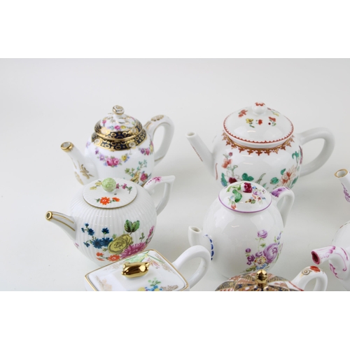 299 - A collection of Franklin Mint Victoria & Albert small teapots to include Meissen, Mennecy, Furstenbu... 