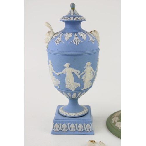 327 - Wedgwood Blue Jasperware two handled urn with Dancing Hours relief to body, ornate mask handle bases... 