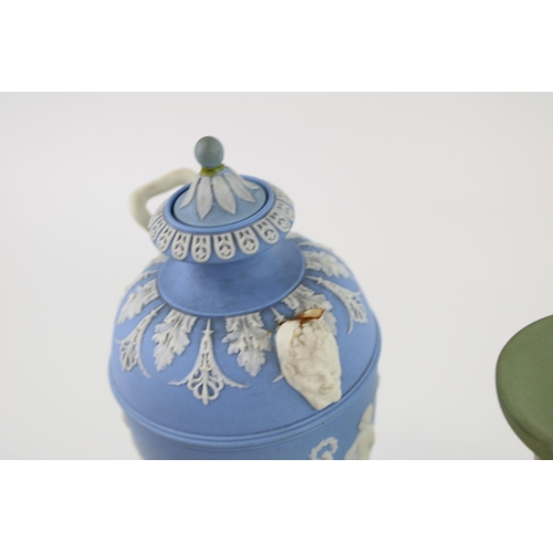 327 - Wedgwood Blue Jasperware two handled urn with Dancing Hours relief to body, ornate mask handle bases... 