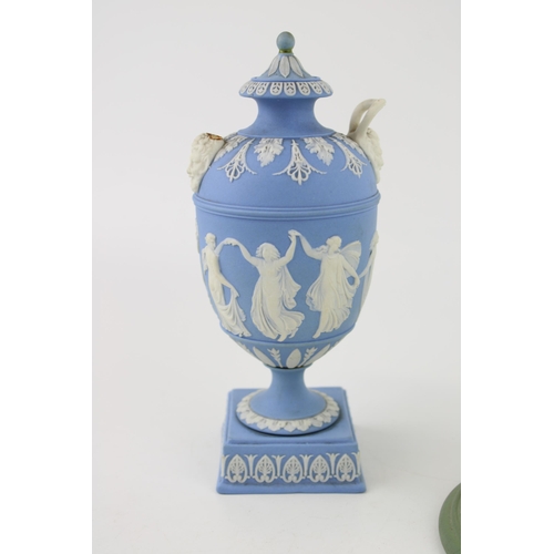 327 - Wedgwood Blue Jasperware two handled urn with Dancing Hours relief to body, ornate mask handle bases... 