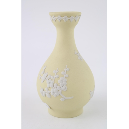 336 - A Wedgwood Jasperware Prunus bud vase in Primrose Yellow. Height 12.5cm.