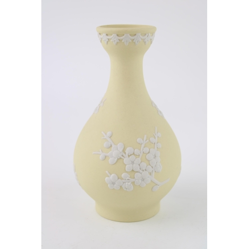 336 - A Wedgwood Jasperware Prunus bud vase in Primrose Yellow. Height 12.5cm.