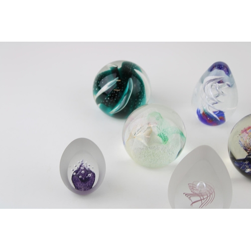 354 - A collection of glass paperweight to include examples by Caithness and Selkirk Glass. (8)