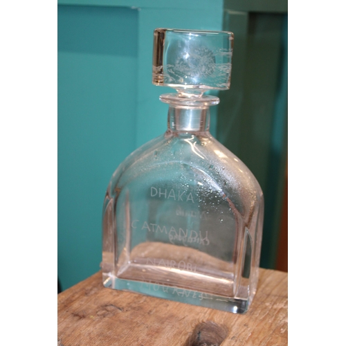 369 - Leslie Smyth glassware decanter with various place names engraved, 23.5cm tall.