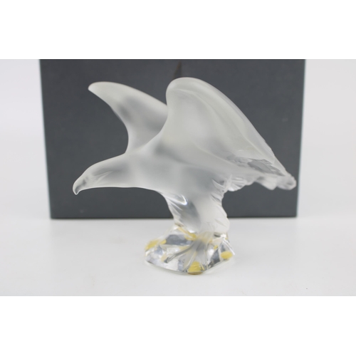 378 - A Lalique frosted sculpture of an eagle perched on a clear base. Lalique sticker on the base, and La... 