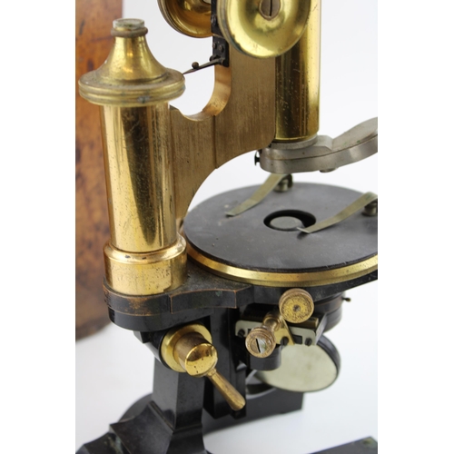 387 - An early c20th brass & steel microscope possibly by Wray, London with spare lenses in the original w... 