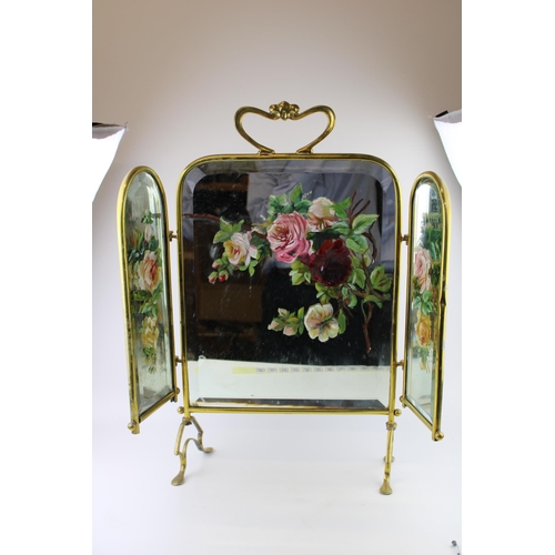 390 - An Edwardian Art Nouveau style brass mirrored and hand painted fire screen