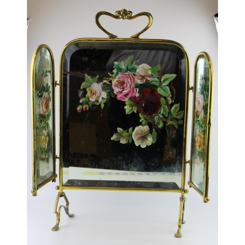 390 - An Edwardian Art Nouveau style brass mirrored and hand painted fire screen