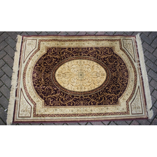 393 - A Persian style carpet in crimsons and creams. Dimensions 175cm x 119cm.