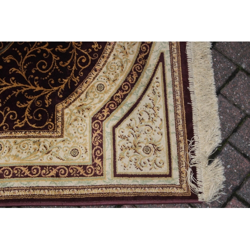 393 - A Persian style carpet in crimsons and creams. Dimensions 175cm x 119cm.