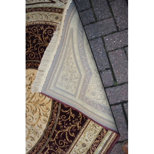 393 - A Persian style carpet in crimsons and creams. Dimensions 175cm x 119cm.