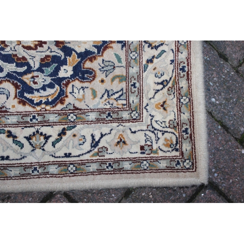 394 - A Persian style runner / rug carpet in blues and creams. Dimensions 182cm x 80cm.