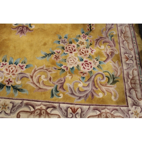 395 - A large Chinese wool carpet in yellow with cream with turquoise. Dimensions 282cm x 255cm.