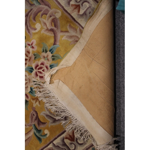 395 - A large Chinese wool carpet in yellow with cream with turquoise. Dimensions 282cm x 255cm.