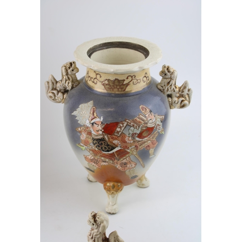 397 - A pair of Early 20th century Satsuma vases Fu Dog finials to lid, ornate handles, raised on three le... 