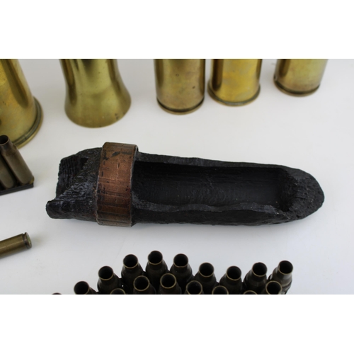 430 - A collection of WW2 and later brass shell cases and bullets to include machine gun bullet belt