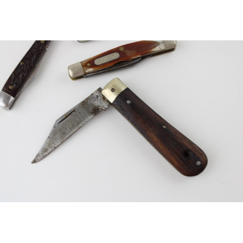 447 - A collection of folding pocket knives to include a wood handle pruner, an 'old timer' USA penknife, ... 