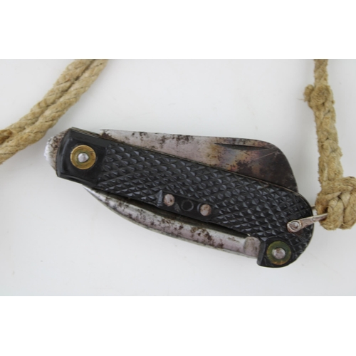 450 - A 1952 dated Army clasp pocket knife by Colin Winand with blade, can opener and marlin spike with la... 