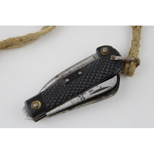 450 - A 1952 dated Army clasp pocket knife by Colin Winand with blade, can opener and marlin spike with la... 