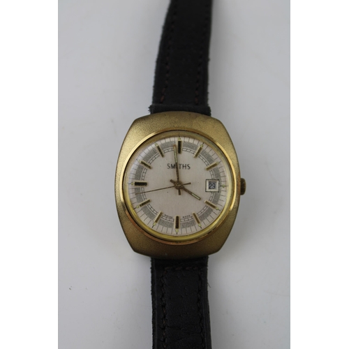 478 - A vintage gentleman's Smiths Baton Swiss Made day date movement watch. Gold tone case on brown leath... 