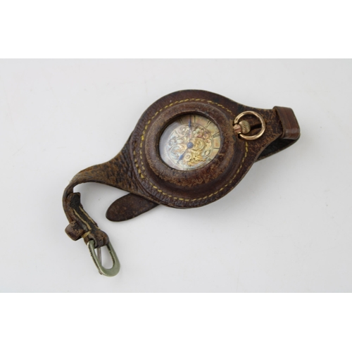 486 - A ladies 9ct gold top winding pocket watch housed in a leather wristlet. Gross weight 25.3g. Case di... 