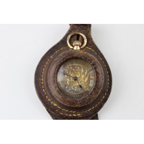 486 - A ladies 9ct gold top winding pocket watch housed in a leather wristlet. Gross weight 25.3g. Case di... 