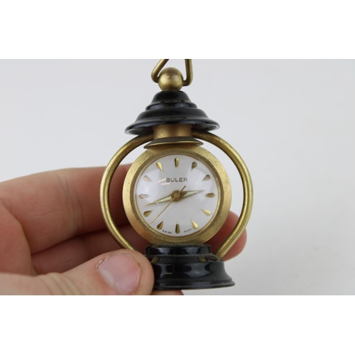 487 - A 'Buler' manual winding miniature lantern clock. Swiss movement with glass back. Height 7cm.