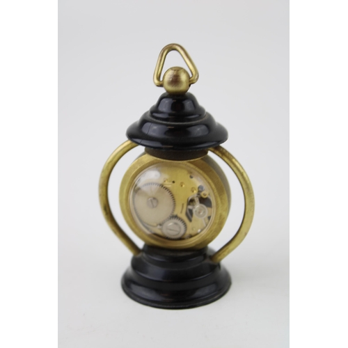 487 - A 'Buler' manual winding miniature lantern clock. Swiss movement with glass back. Height 7cm.