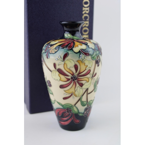 49 - Boxed Moorcroft Honeysuckle Haven trial vase, first quality, 15.5cm tall.