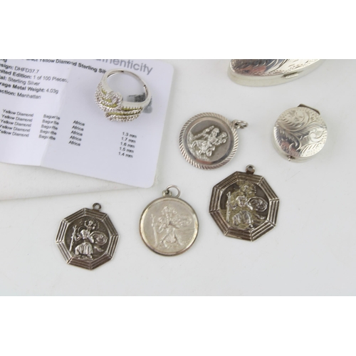 505 - A collection of silver items to include two pill boxes, four St Christophers and a yellow diamond an... 