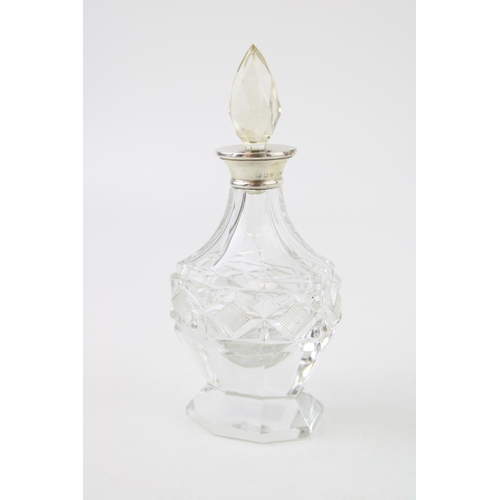 521 - Silver ornate perfume bottle, London 1929, Wolfski & Co, 14cm tall, with stopper.