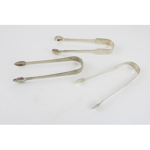 538 - Three pairs of silver tongs to include a pair of Georgian bright cut tongs, London, circa 1795, P & ... 