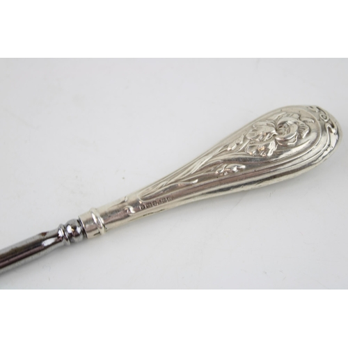 539 - A large silver handled button hook, Birmingham 1906, H Matthews, with a sterling silver condiment sp... 