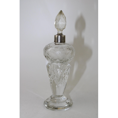 551 - Silver and glass perfume bottle, etched floral decoration, with stopper, 16cm tall.