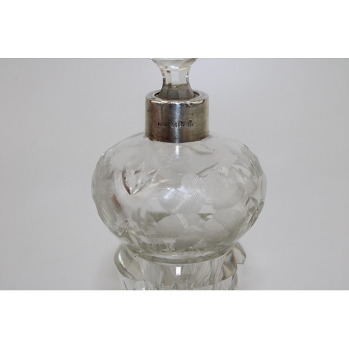 551 - Silver and glass perfume bottle, etched floral decoration, with stopper, 16cm tall.