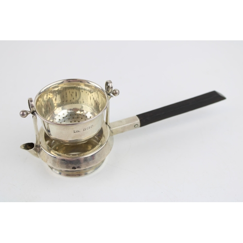 552 - Silver novelty tea strainer, ebonised wooden handle, Birmingham 1916, Walker & Hall, 16.5cm long.