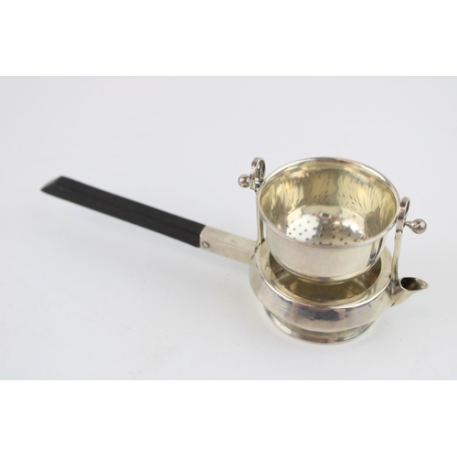 552 - Silver novelty tea strainer, ebonised wooden handle, Birmingham 1916, Walker & Hall, 16.5cm long.