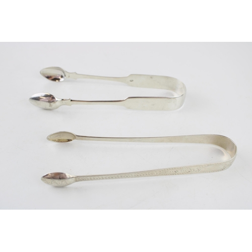 556 - Two pairs of silver tongs to include a Georgian bright cut pair of tongs, London, with a pair London... 